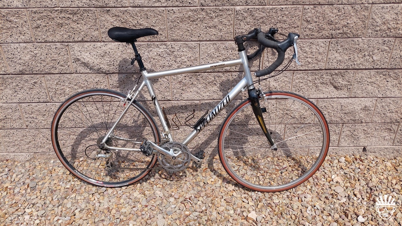 Silver frame Specialized Sequoia Expert leaning against wall